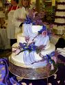 ROLLED FONDANT 3 TIER WITH PURPLE DRAPE AND FLOWERS